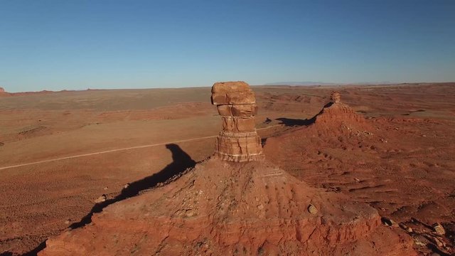 Aerial drone footage of butte and sandstone monument in Utah (sideways views)