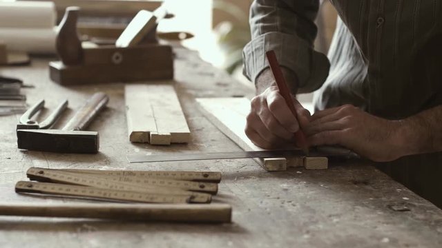 Carpenter measuring and marking with precision on wood