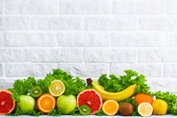 Healthy food fruits background on white painted brick wall