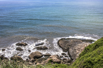 Waves hit the rocks on a beach in Itanhaem