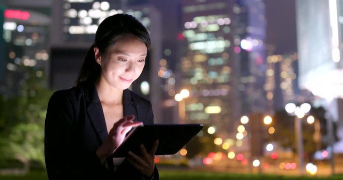 Asian business woman use of mobile phone at night