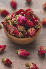 Dried Pink Rose Buds in a Brown Bowl