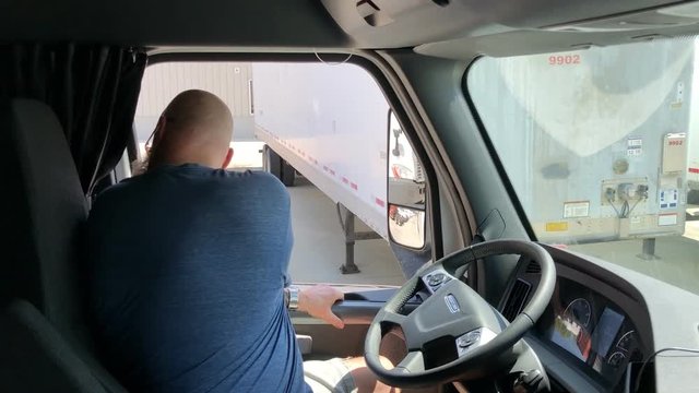Man climbing into semi truck preparing for road rip