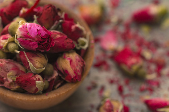 Dried Pink Rose Buds in a Brown Bowl
