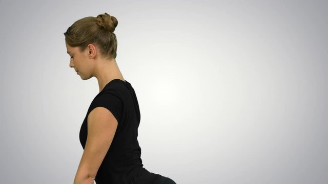 Side view portrait of beautiful young woman doing yoga or pilates exercise. One Legged King Pigeon pose, Eka Pada Rajakapotasana on white background
