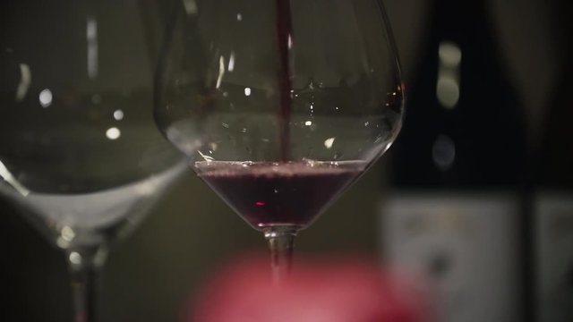 Two glasses being filled with pinot noir