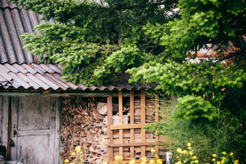 Old forest hunter's house with harvested wood. Hunting cabin.