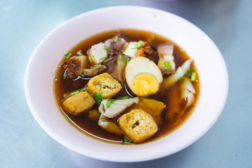 chinese roll noodles soup with pork and egg