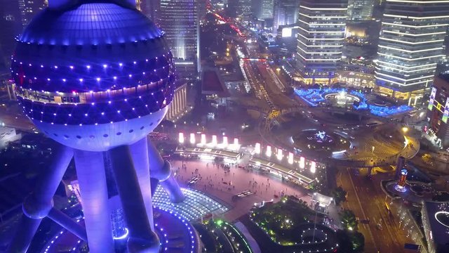 Night illumination Oriental Pearl Tower Television Shanghai China light modern multicolored futuristic urban skyscrapers Active Road traffic junction Pudong Area People tourists walk Aerial Drift near