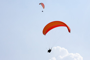 Paraglider flying on a wing in the sky