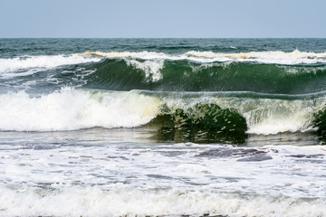 Waves breaking on the Caribbean Sea with blue sky in the background, as a nature background
