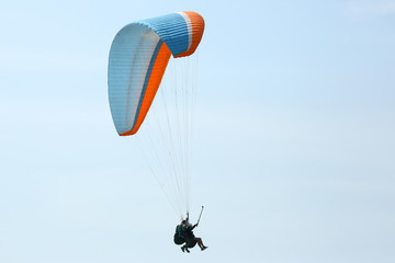 Paraglider flying on a wing in the sky
