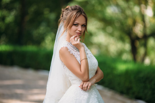 Portrait Of A Crafty Bride Who Conceived Something. A Girl Is Posing In A Lace Wedding Dress. The Blonde Is Getting Married Today.