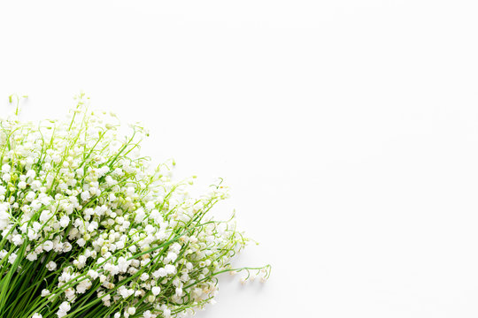 Small And Fragrant Spring Flowers. Bouqet Of Lily Of The Valley Flowers On White Background Top View Copy Space