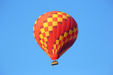 Colored balloon with people flying in the sky in Cappadocia
