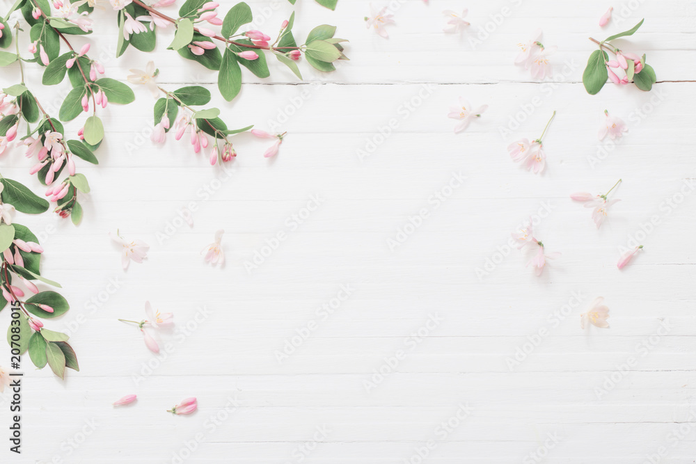 Poster branches of bush with pink flowers on wooden background