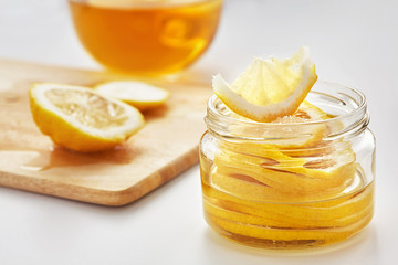 lemon with sugar is in a glass jar