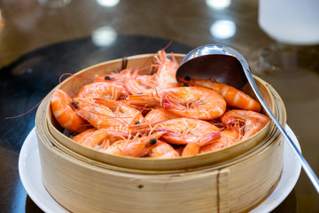 Shrimps heap boiled with scoop in wooden basket