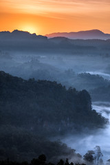 Sunrise shine on mountain in fog valley
