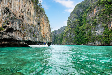 Motor boat sailing on mountain limestone Pileh lagoon at Phi Phi island