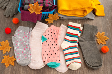 Socks for cold seasons. Multi-colored knitted socks of different sizes. Socks for autumn and winter. Warm clothes.