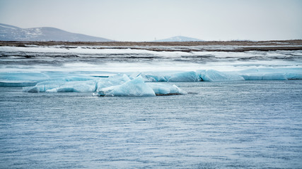 The thawed river and blue glaciers