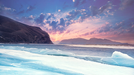 blue glaciers on the background of mountains and gentle beautiful sunset