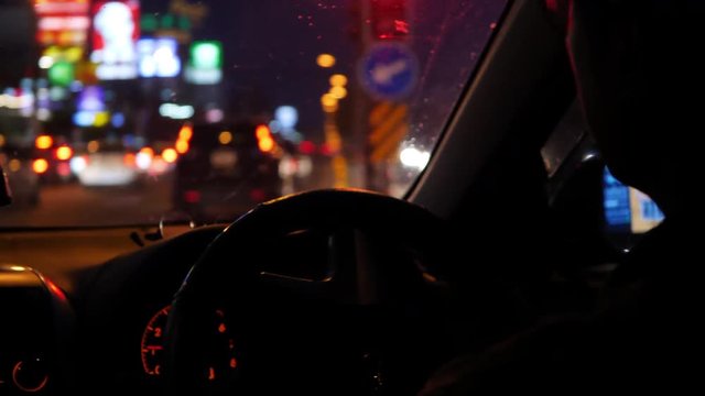 car driving in night city with traffic jam