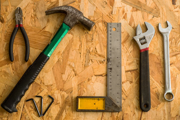 set of carpentry tools on wood background . flat lay tools working space for carpenter , top view.