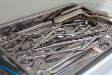 Medical scissors, tweezers and other tools in a stainless steel tray