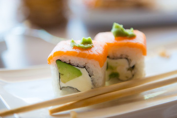 Sushi with salmon and wasabi on a platter. Japanese cuisine.