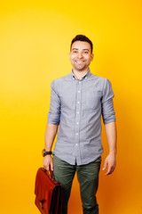 Portrait of happy young afro american student smiling over yellow background