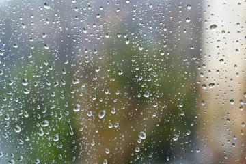 Naklejka na ściany i meble Rain drops on window glasses surface