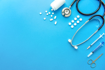 Pills and medical equiupments on light blue background