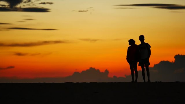 Travel Video The couple are showing a nice romantic moment in the sunset during the honeymoon at the tropical beach.