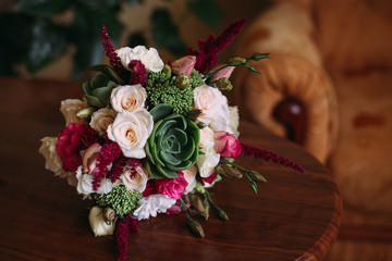 incredible wedding bouquet of roses lying on a wooden table