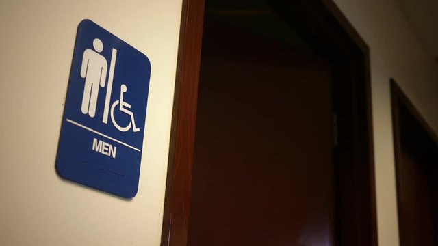 Man exits a bathroom in an office building
