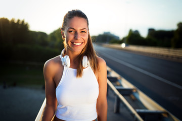 Portrait of woman taking break from jogging