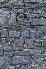 old stone wall of stones of different sizes close-up