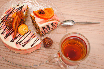 close up carrot slice cake and a cup of tea on wooden background top view