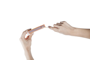 Female hands holding a matchbox on isolated background