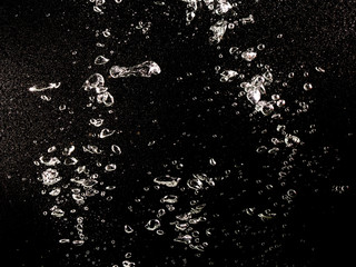 Bubbles of air in water on a black background