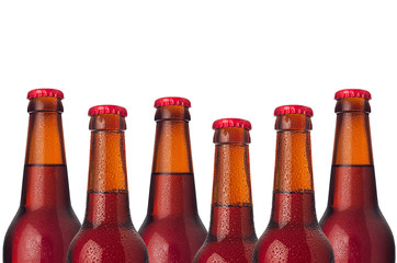 Decorative border of sealed lager beer bottles isolated on white background. Design concept for...