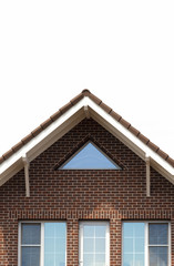 A large beautiful modern brick house close-up on a white background.