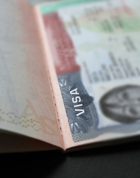 Visa stamp travel passport immigration macro emigration. Close up of text VISA on USA visa stamp in passport. A visitor needs a valid US visa to present to the CBP officer (customs and border protecti