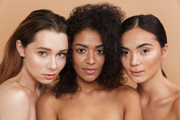 Close up image of three sensual naked women posing together