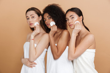Three beauty women wearing in towels posing together