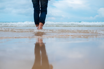 nature background close up lag of woman standing alone on beach with copy space. image for person,...