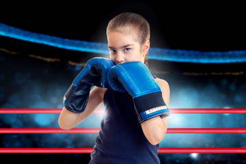 Cute little girl with blue eyes in boxing ring