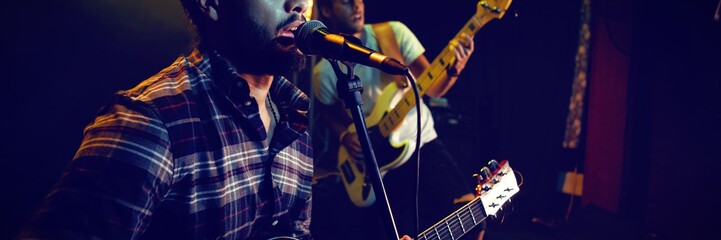 Obraz premium Male guitarists on stage in nightclub